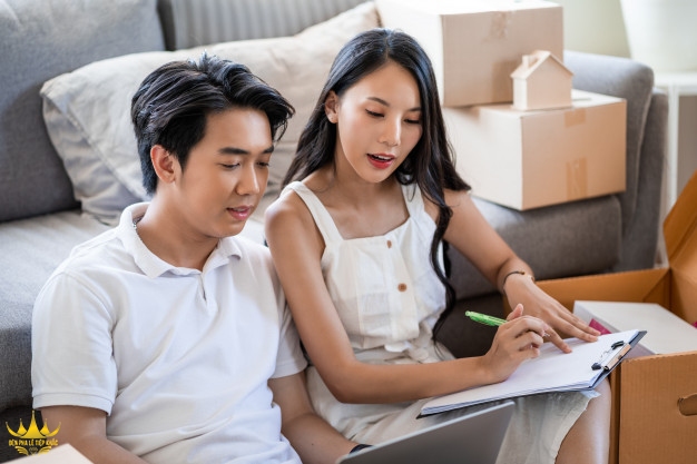 young beautiful asian couple love moving new home sitting floor very happy cheerful new apartment around cardboard boxes holding cardboard boxes while moving home 33413 418